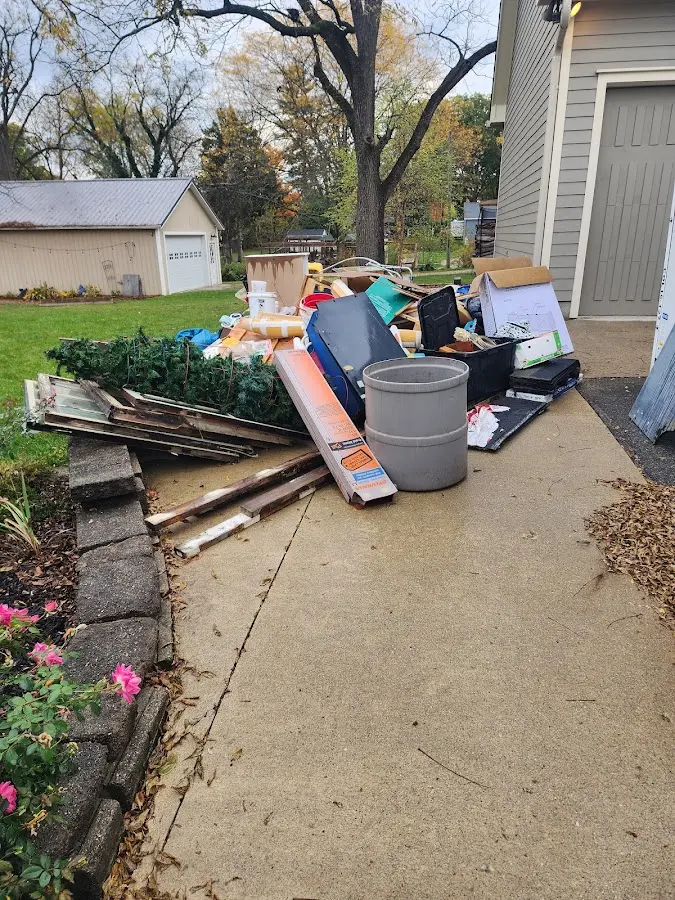Dumpster being loaded with debris for Estate Cleanout Dumpster Rental in Andover
